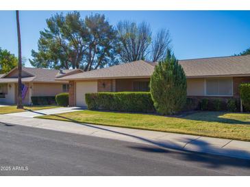 Single-story home with a well-manicured lawn and attached garage at 9614 N 110Th Ave, Sun City, AZ 85351
