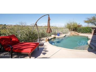 Inviting backyard oasis with a sparkling pool and relaxing lounge chair at 15720 E Yucca Dr, Fountain Hills, AZ 85268