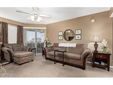 Living room with couch, chair, and decorative pieces at 1720 E Thunderbird Rd # 2059, Phoenix, AZ 85022