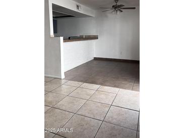 Kitchen features gray cabinets, tile flooring and modern appliances at 18202 N Cave Creek Rd # 128, Phoenix, AZ 85032