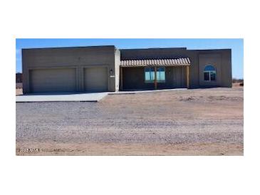 Two-car garage and desert landscaping surround this one-story home at 24301 N 194Th Ave, Surprise, AZ 85387