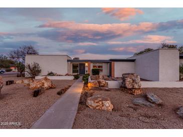 Mid-century modern home with landscaped yard and unique rock features at 2609 S Country Club Way, Tempe, AZ 85282