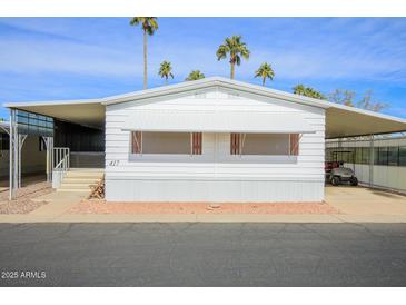 Mobile home with carport and palm trees at 305 S Val Vista Dr # 417, Mesa, AZ 85204