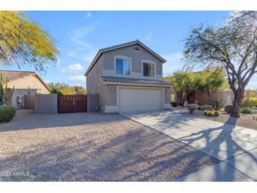 Two-story house with a beige exterior, two-car garage, and desert landscaping at 4529 E Coyote Wash Dr, Cave Creek, AZ 85331