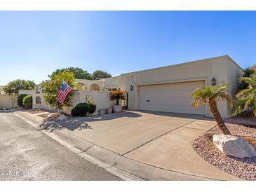 Single story home with light colored stucco and attached garage at 6945 E Glenrosa Ave, Scottsdale, AZ 85251