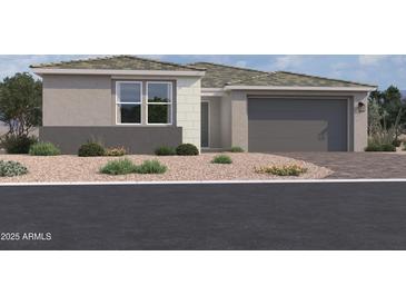 Single-story home with gray exterior, two-car garage, and desert landscaping at 7638 W Rowel Rd, Peoria, AZ 85383