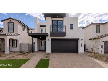 Modern two-story home with a two-car garage and balcony at 10249 E Ulysses Ave, Mesa, AZ 85212