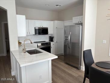 Modern kitchen with stainless steel appliances and white cabinetry at 1314 E Thompson Way, Chandler, AZ 85286