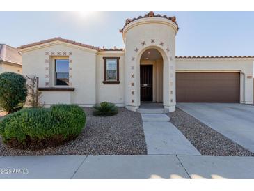 One-story home with stucco exterior, arched entryway, and a two-car garage at 22543 E Calle De Flores --, Queen Creek, AZ 85142