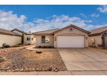 Single-story house with a two-car garage and desert landscaping at 3041 E Wahalla Ln, Phoenix, AZ 85050