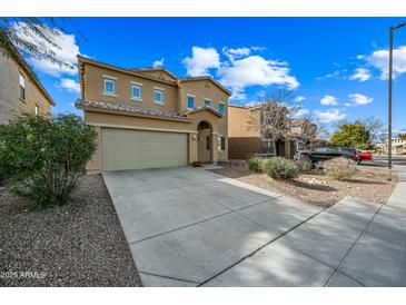 Two-story house with tan exterior, shutters, and a two-car garage at 3743 W Wayne Ln, Anthem, AZ 85086