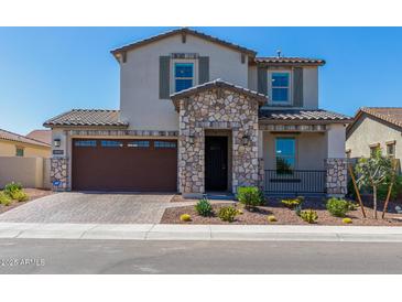 Two-story house with stone accents and a brown garage door at 4334 N Pioneer Dr, Litchfield Park, AZ 85340