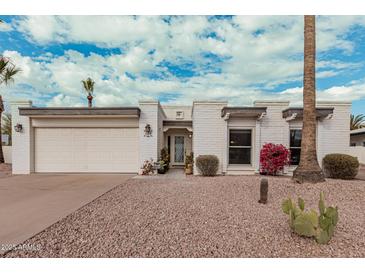 White single story home with a two-car garage and nicely landscaped yard at 628 E Calavar Rd, Phoenix, AZ 85022