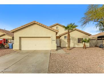 Single-story house with a two-car garage and desert landscaping at 6314 W Virginia Ave, Phoenix, AZ 85035