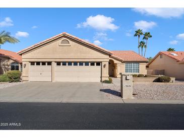 Charming single-story home with a three-car garage and well-maintained desert landscaping at 10626 E Voax Dr, Sun Lakes, AZ 85248