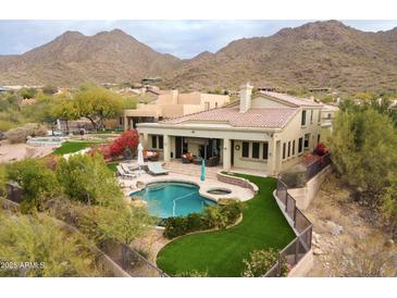 Luxury home with a pool, mountain views, and a spacious backyard at 12026 N 138Th St, Scottsdale, AZ 85259