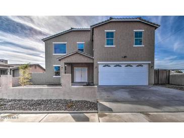 Two-story house with a white garage door and stone facade at 12321 W Florence St, Avondale, AZ 85323