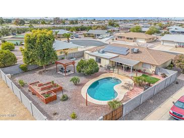 Aerial view of house, pool, and backyard with garden at 12411 N Cantata Ct, Sun City, AZ 85351