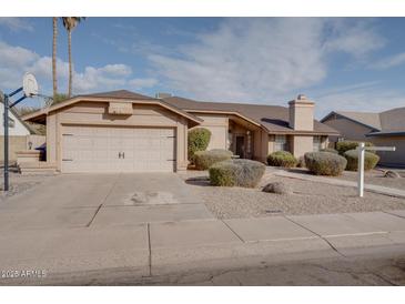 Single-story house with a two-car garage and well-manicured landscaping at 1354 E Brentrup Dr, Tempe, AZ 85283