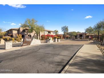 Gated community entrance with landscaped grounds and signage at 19777 N 76Th St # 2292, Scottsdale, AZ 85255