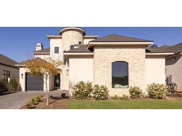 Stunning two-story home with stone accents and a three-car garage at 20684 E Natalie Way, Queen Creek, AZ 85142