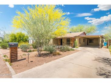 Cute bungalow with a carport and nicely landscaped front yard at 2434 E Pinchot Ave, Phoenix, AZ 85016