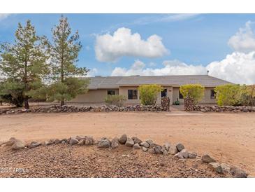 Ranch style home with rock wall accents and mature landscaping at 313 W Saddle Mountain Rd, Phoenix, AZ 85086