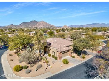 Aerial view of a single-story home with a desert landscape and mountain views at 33108 N 72Nd Way, Scottsdale, AZ 85266