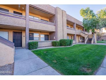 Attractive condo building with landscaping and walkway at 3535 W Tierra Buena Ln # 156, Phoenix, AZ 85053