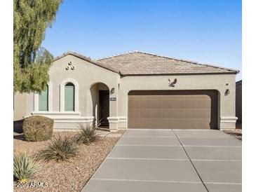 Charming single-story home with a two-car garage and well-maintained front yard at 4916 E Rhodium Dr, San Tan Valley, AZ 85143