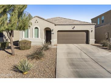 Single-story home with a two-car garage and desert landscaping at 4916 E Rhodium Dr, San Tan Valley, AZ 85143