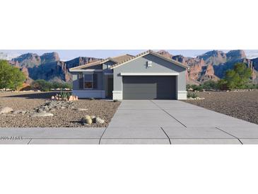 Single-story home with a two-car garage and desert landscaping at 5515 E Rock Bush Ln, San Tan Valley, AZ 85140