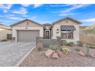 Single-story home with gray garage door and brick accents at 8043 E Jaeger St, Mesa, AZ 85207