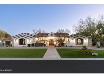 Stunning Spanish-style home with a beautifully landscaped front yard at 8515 E Sutton Dr, Scottsdale, AZ 85260