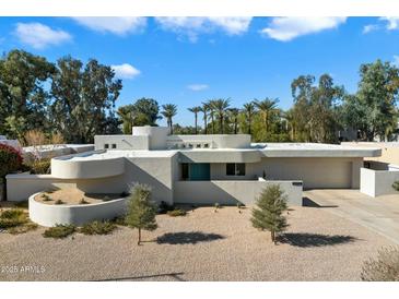 Mid-century modern home with clean lines and a landscaped yard at 9448 N 80Th Pl, Scottsdale, AZ 85258