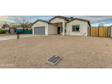 Newly built home with gray garage door and neutral exterior at 10869 N 81St Ave, Peoria, AZ 85345