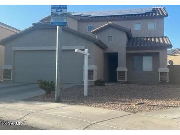 Two-story house with attached garage and solar panels at 11534 W Longley Ln, Youngtown, AZ 85363