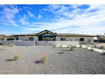 Modern single-story home with clean lines and a landscaped front yard at 12201 N 65Th St, Scottsdale, AZ 85254