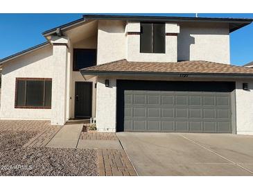 Two-story house with gray garage door and landscaped walkway at 1722 W Brooks St, Chandler, AZ 85224