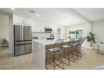 Modern kitchen with stainless steel appliances and white shaker cabinets at 2003 E Magdalena Dr, Tempe, AZ 85283