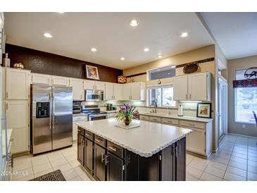 Bright kitchen features stainless steel appliances and an island at 21413 N 159Th Dr, Sun City West, AZ 85375