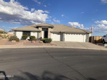 Single-story home with a three-car garage and landscaped front yard at 2705 S Copperwood --, Mesa, AZ 85209