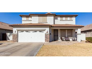 Two-story house with a white garage door and brown roof at 29808 N Yellow Bee Dr, San Tan Valley, AZ 85143