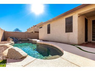 Inviting backyard oasis featuring a sparkling pool and serene landscaping at 30061 N 70Th Dr, Peoria, AZ 85383