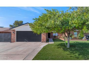 Brick home with a 2-car garage and a well-manicured lawn at 4642 N 31St St, Phoenix, AZ 85016