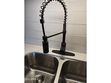 Modern kitchen sink with black faucet and stainless steel basin at 5031 W Flynn Ln, Glendale, AZ 85301