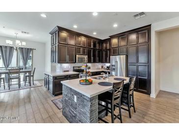 Modern kitchen with stainless steel appliances and an island at 6565 E Thomas Rd # 1015, Scottsdale, AZ 85251