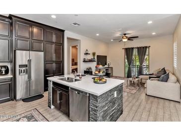 Open concept kitchen and living area with modern finishes at 6565 E Thomas Rd # 1015, Scottsdale, AZ 85251