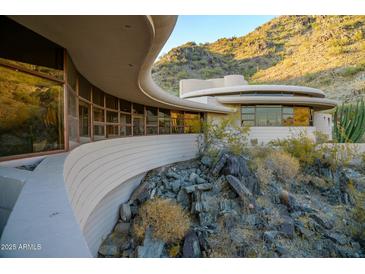 Curved concrete home with expansive windows overlooking desert landscape at 6836 N 36Th St, Phoenix, AZ 85018