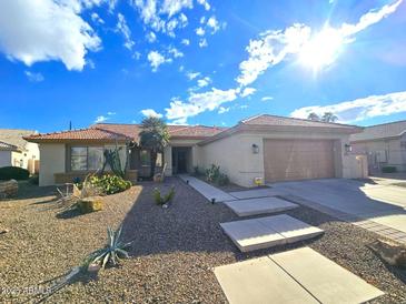 Single-story home with desert landscaping and a two-car garage at 10329 E Sunridge Dr, Sun Lakes, AZ 85248